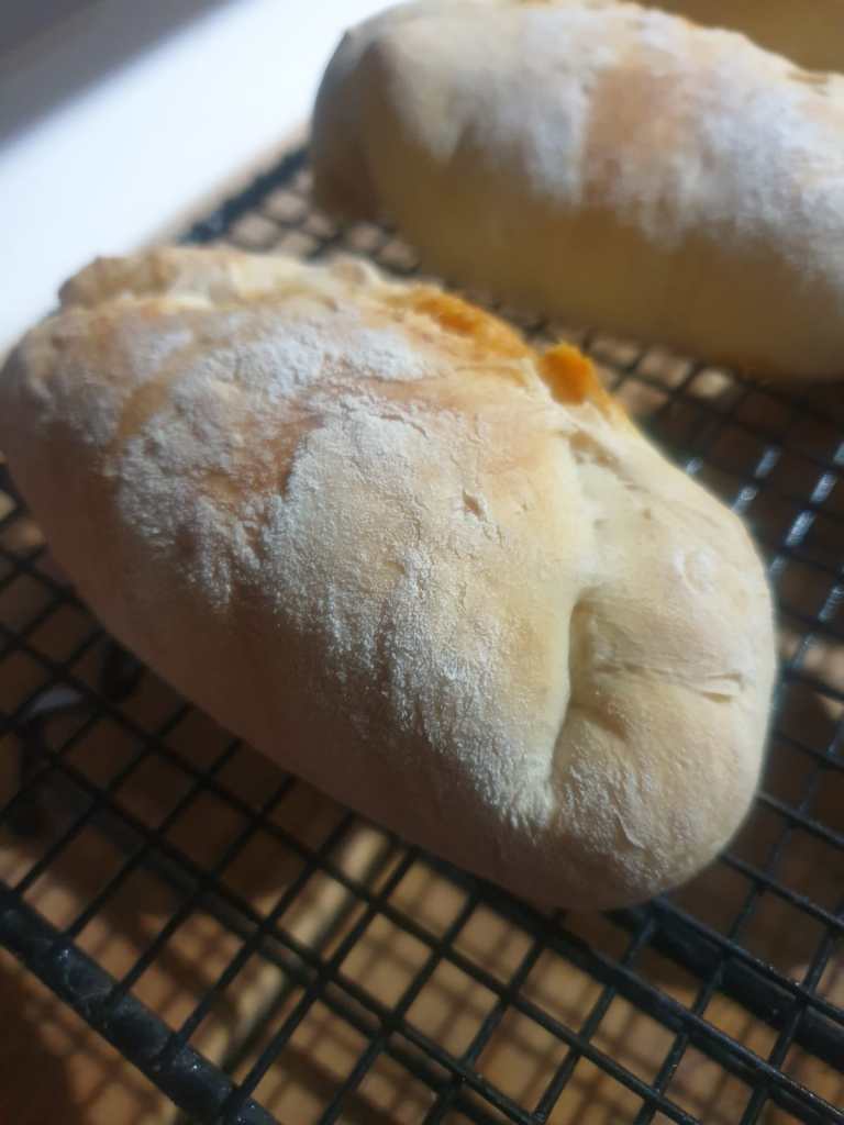 Picture of a cooked mini calzone on a cooling wrack. 