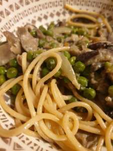 Bowl of garlic mushroom pasta, close up.